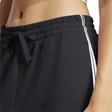 Pantalón de jogging Adidas Essentials French Terry Cuffed 3 Bandas, color gris oscuro, con cintura elástica ajustable con cordón, bolsillos laterales, puños acanalados y logo de la marca bordado en blanco.