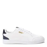 Championes Puma modelo Shuffle, de diseño urbano con silueta de bota baja. Presentan una parte superior de cuero sintético negro con la icónica franja lateral blanca y detalles en dorado. Incluyen perforaciones en la puntera para mayor ventilación y una suela de goma blanca.