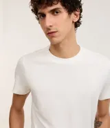 Remera masculina blanca, modelo muscle con cuello redondo y manga corta. Sin estampado, confeccionada en algodón certificado BCI.