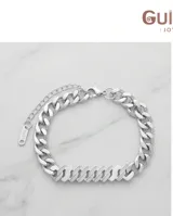 Pulsera de eslabones cubanos de acero, con una sección central pavé de circonias y cadena de alargue con cierre de mosquetón.