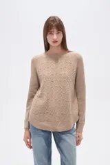 Sweater de algodón color beige con diseño de punto en relieve en forma de zigzag y pequeños puntos. Tiene cuello redondo y mangas largas tipo ranglán.