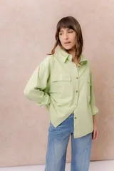 Camisa oversize de denim liviano color amarillo, con cuello camisero, mangas largas con puños, bolsillos delanteros con tapa y ruedo desflecado.