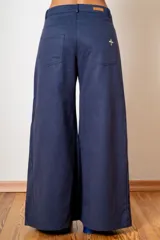 Pantalon de corte wide leg en color bordó, con cintura alta, cierre frontal con botón y bolsillos laterales.