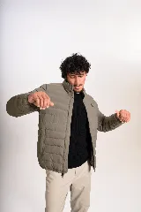 Campera puffer verde militar, de cuello alto, con cierre frontal y bolsillos laterales.