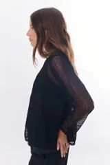 Sweater de tejido de punto calado color lila, con cuello en V y mangas largas.