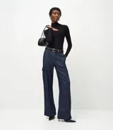 Pantalón wide leg de jean azul oscuro, con cintura media, bolsillos cargo laterales con solapa y cierre frontal con botón y cremallera.