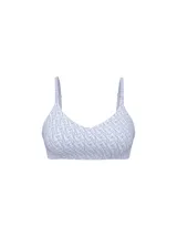 Sujetador inalámbrico tipo bralette con escote pronunciado, color lila con estampado de monogramas de la marca y tirantes elásticos ajustables con inscripciones.