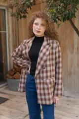 Blazer de paño con estampa a cuadros en tonos marrones y beige, de corte recto y mangas largas.