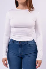 Remera de manga larga y cuello redondo, confeccionada en algodón con lycra, de calce entallado al cuerpo.