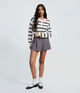 Short de sastrería color gris, con diseño estructurado, pliegues delanteros y cierre interno. Incluye un cinturón fino desmontable.