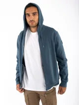 Campera canguro Kevingston de jersey frisado invisible de algodón, en color azul. Presenta cierre frontal completo, capucha con cordón ajustable y bolsillos delanteros amplios tipo canguro.