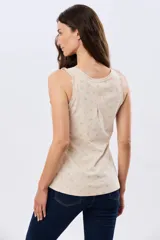 Musculosa de algodón blanca con pequeño estampado floral y volados en los tirantes, de corte clásico.