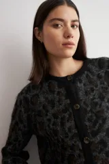 Cardigan de punto con estampado animal print en tonos gris oscuro y negro, con cuello redondo, cierre frontal de botones y mangas largas.