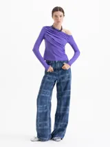 Top de manga larga color violeta, con diseño asimétrico de un solo hombro y detalle de drapeado frontal. Confeccionado en tejido de punto con acabado brillante.