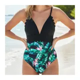 Malla enteriza bicolor de diseño combinado, con parte superior lisa en color negro de escote en V pronunciado con bordes ondulados, y parte inferior con estampado botánico de hojas verdes y flores rosadas sobre fondo negro. Cuenta con tirantes finos regulables.