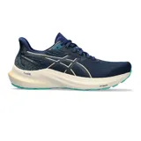Championes de running Asics GT-2000 12 para mujer, color azul marino con entresuela blanca, detalles en dorado y suela verde turquesa. Confeccionados en tejido de malla transpirable, incorporan tecnología FF Blast+ y PureGel para mayor amortiguación.