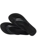 Sandalias tipo ojota Havaianas color negro, con diseño de plataforma y tiras finas con textura grabada.