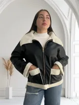 Campera de ecocuero negra con interior de corderito blanco, cierre frontal con cremallera y bolsillos laterales.