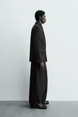 Blazer de corte regular confeccionada en tejido con lana, con diseño de doble botonadura. Presenta solapas de muesca en tejido combinado a tono, manga larga con puños abotonados, bolsillos laterales con solapa y bolsillo de vivo en el pecho.