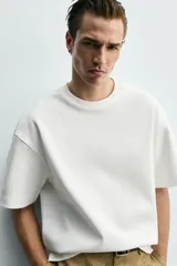 Sudadera de corte relajado confeccionada en tejido técnico interlock con mezcla de algodón, cuello redondo y manga corta.