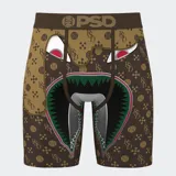 Calzoncillos bóxer PSD con estampado de un rostro de caricatura con dientes afilados y logo de la marca en la cintura.