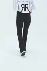 Calza negra de lycra gruesa, tiro alto y corte semi-oxford con abertura en el tobillo.