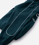 Buzo de cuello alto con medio cierre frontal, confeccionado en tejido de algodón con felpa. Presenta un corte boxy holgado, mangas largas con puños elásticos y una estampa gráfica circular en la espalda con la inscripción Off-Track Studio Company.