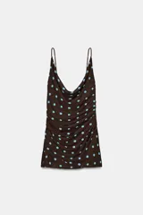 Vestido corto de escote fluido con tirantes finos ajustables. Presenta un diseño con frunces en la parte delantera y cierre lateral con cremallera oculta.