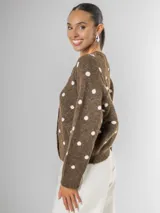 Cardigan tejido color marrón, con botones frontales y estampado de lunares blancos.