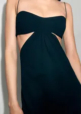 Vestido largo negro de la colaboración Supriya Lele x Mango, confeccionado en poliéster con forro de poliamida y elastano. Presenta diseño recto, tirantes finos, escote pronunciado, aberturas cut-out en los laterales y bajo asimétrico.