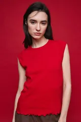 Remera sin mangas de silueta entallada y corte al cuerpo, confeccionada en algodón elastizado con textura acanalada y escote redondo.