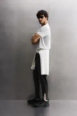 Pantalón negro de entrenamiento slim fit confeccionado en tejido técnico ligero y elástico con estructura. Cuenta con cintura elástica ajustable con cordón, bolsillos frontales y trasero con cierre de cremallera, y bajo ajustable con cremallera en laterales.