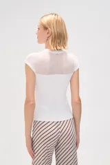 Remera de punto al cuerpo con diseño calado en la parte superior y cuello redondo, de manga corta.