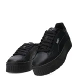 Championes Puma Karmen II Leather de color negro, con diseño urbano y plataforma. Presentan un upper de cuero con detalles sintéticos, cierre de cordones y plantilla SoftFoam+ para mayor amortiguación. La suela de goma robusta proporciona estabilidad y altura.