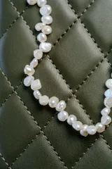 Collar de perlas de agua dulce naturales con formas irregulares, montado sobre una cadena de acero quirúrgico.