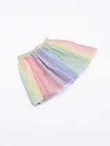 Pollera corta de tul con cintura elástica dorada y estampado de estrellas doradas. Diseño con paneles verticales en colores pastel: rosa, amarillo, verde, celeste y lila.