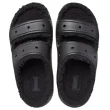 Sandalias tipo mule negras con plataforma, forradas con material afelpado negro en las tiras y el interior. Presentan dos tiras ajustables con hebillas y orificios para dijes Jibbitz™.