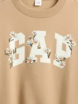 Buzo de cuello redondo y manga larga en color beige, con el logo de la marca estampado en el frente decorado con un diseño floral.