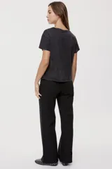 Pantalón de tiro medio y corte wide leg color beige, con diseño clásico de cinco bolsillos, presillas para cinto y cierre frontal con botón y cremallera.