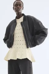 Top de punto pointelle H&M Edition, color beige, sin mangas, con cuello redondo y diseño acampanado con peplum.