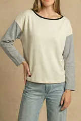 Sweater de corte oversize con diseño bicolor, cuerpo en color crema y mangas largas en gris melange, con cuello redondo en contraste negro.