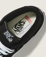 Championes de skate Vans modelo Half Cab, de corte medio, confeccionados en gamuza y lona color negro con costuras blancas. Presentan suela de goma blanca vulcanizada, cordones blancos y etiqueta distintiva en el lateral y la lengüeta.