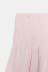 Pantalón baggy de tiro medio color rosado, con cintura elástica fruncida tipo nido de abeja y bajos ajustables con cordones.