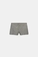 Shorts de tiro medio con diseño de cuadros, cuentan con trabillas en la cintura, bolsillos de vivo y cierre frontal con cremallera, botón y ganchos metálicos.