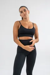 Top deportivo negro con breteles finos y diseño texturizado.