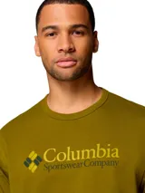 Remera de algodón de alto gramaje marca Columbia, color verde oliva, con cuello redondo y el logotipo estampado en el pecho en tonos amarillos y oscuros.