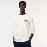 Buzo de felpa color blanco hueso, con cuello redondo y puños y ruedo acanalados. Presenta una pequeña impresión en el pecho con texto que incluye "EAST KENSINGTON PHILADELPHIA".