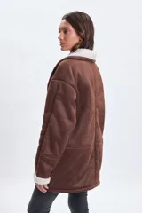 Chaqueta de abrigo color marrón con interior y solapas forradas en sherpa color crema. Presenta diseño de corte recto, mangas largas con puños de sherpa y bolsillos laterales.