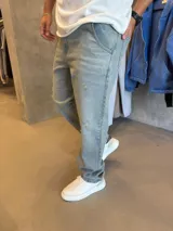 Jean de corte mom con efecto lavado claro y detalles de roturas sutiles en la parte frontal. Cuenta con cierre y botón metálico, bolsillos laterales y traseros.