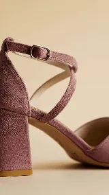 Zapato de tacón ancho de 5 cm, confeccionado en tela de tapicería resistente color negro. Presenta un diseño con escote en V y tiras cruzadas en diagonal con cierre de hebilla en el tobillo. Cuenta con forro y plantilla de cuero.